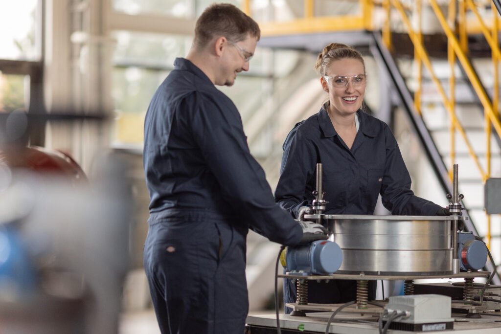 Two IperionX workers using titanium.