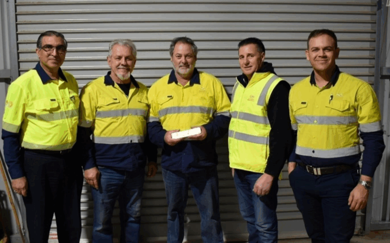 Chief executive Dean Goodwin holding Classic’s first gold bar with the team.
