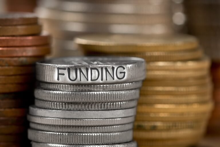 Stack of coins with the word funding etched on one.