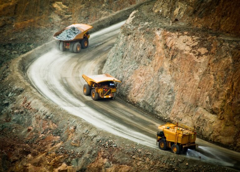 Three trucks transporting material in a gold mine.