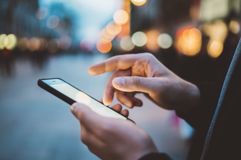 Close up of male using a smartphone.