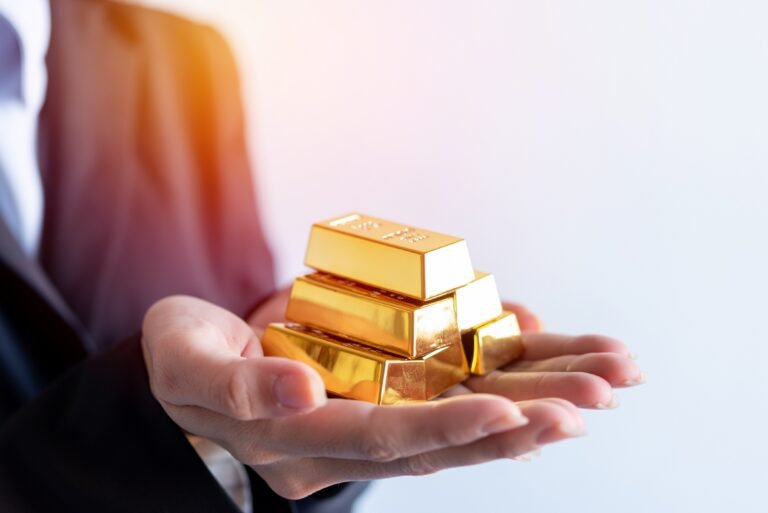 Person holding gold bars.