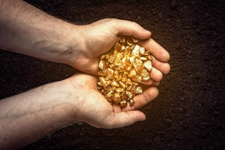 Man holding gold nuggets.