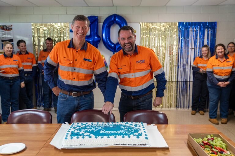 APO General Manager Port Operations Allan Brown and NQXT General Manager Mark Smith cut the cake