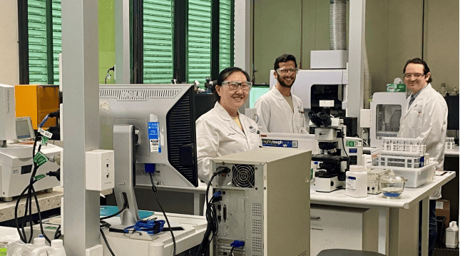 (Image source: QEM) University of Queensland Hydrometallurgy Research Laboratories, part of the School of Chemical Engineering, analytical laboratory team members Tseeveenkhuu Darinchuluun in the foreground and Vitor Loureiro and James Gudgeon in the background.