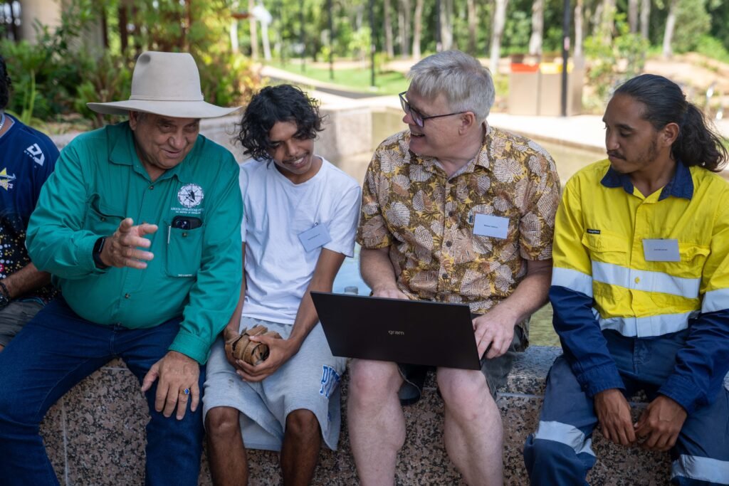 Jangga Elder Col McLennan shows Jangga community members the Let’s Talk Yangga website.