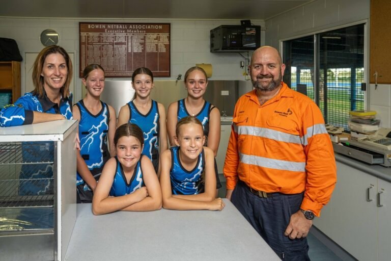 (Image source: Bowen Rail Company) From L-R: Netball Association secretary Michelle Bossen and Cyclones players with Bowen Rail Company health, safety and community manager Marty Trask with Bowen in their refurbished kitchen.