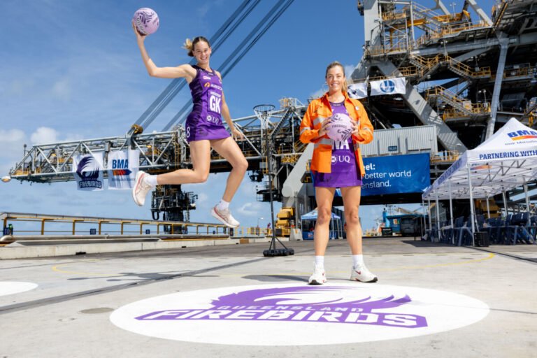 (Image source: BHP) Pictured L-R are Queensland Firebird’s Isabelle Shearer and Lara Dunkley at BMA’s Hay Point coal terminal.