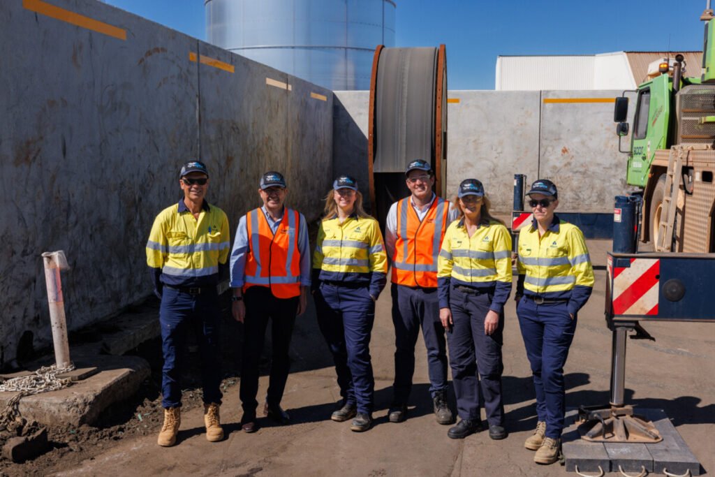 (Image source: Brodie Butler Photography) Members of the Alcoa and Tyrecycle teams in front of the first of 80 reels of used conveyer belt from Alcoa’s mine sites. From left, Michael White, Jim Fairweather, Nicole King, Ashley Battilana, Lisa Flynn and Katrina Naylor.  
